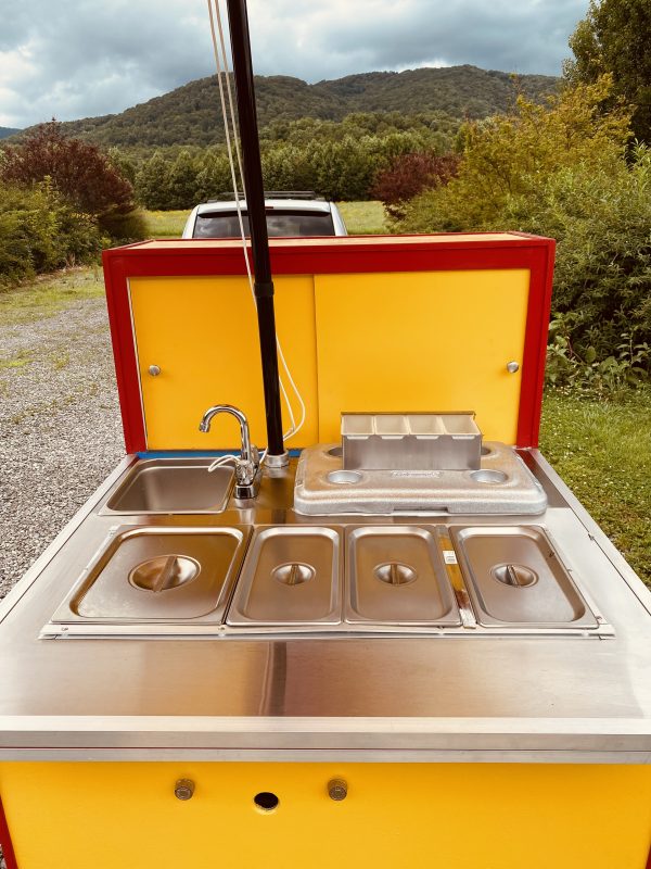 cart top with pans and lids